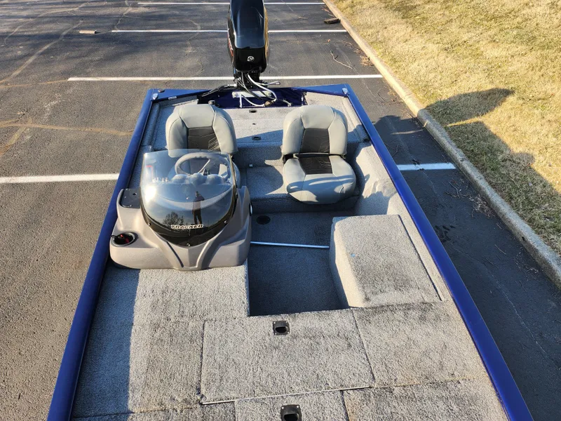 Slide: The Image of 2021 Tracker Pro 170 boat with dual seats in a parking lot. - 19