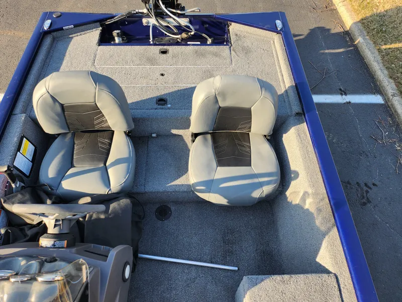 Slide: The Image of 2021 Tracker Pro 170 boat interior with two gray seats and steering console. - 20