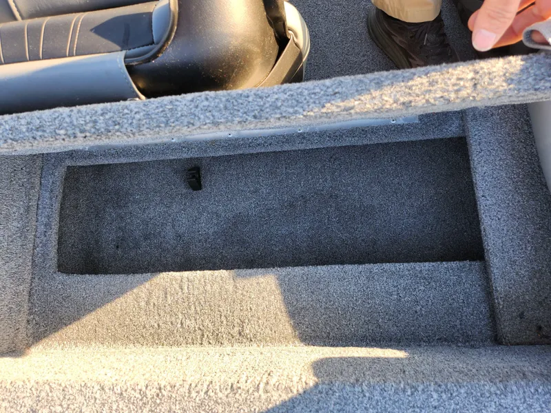 Slide: The Image of 2021 Tracker Pro 170 boat storage compartment with gray carpet interior. - 21