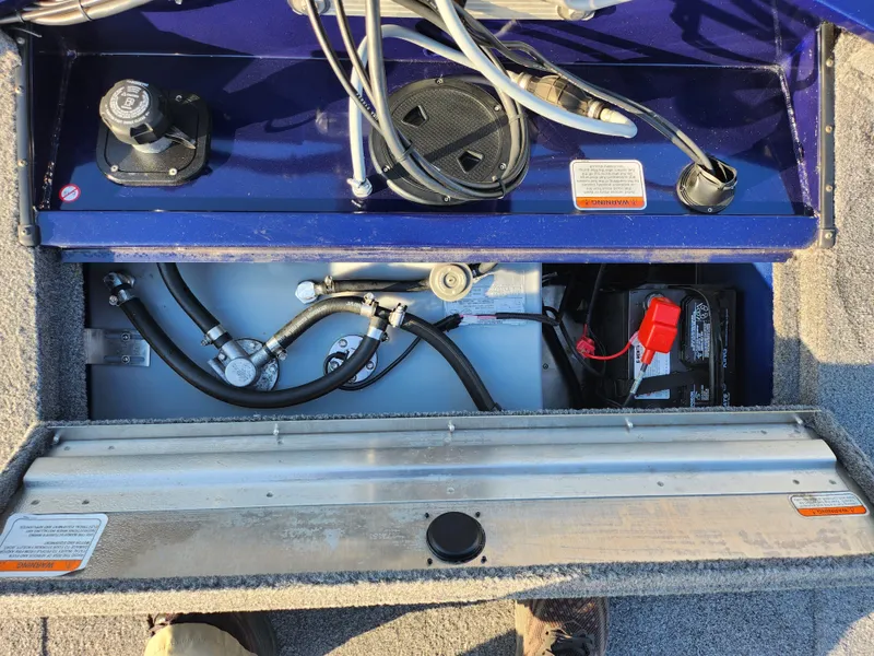 Slide: The Image of 2021 Tracker Pro 170 boat interior showing battery and wiring components. - 24