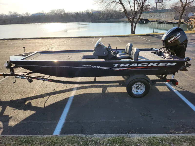 Slide: The Image of 2021 Tracker Pro 170 boat parked near a lake, featuring a Mercury outboard motor. - 9