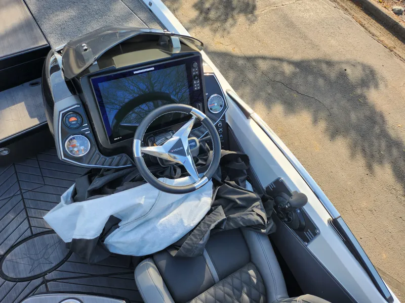 Slide: The Image of 2023 Vexus VX20 boat cockpit with steering wheel and navigation display. - 12