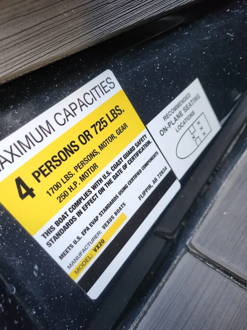 Slide: The Image of 2023 Vexus VX20 capacity label, maximum 4 persons or 725 lbs, safety compliance details. - 13