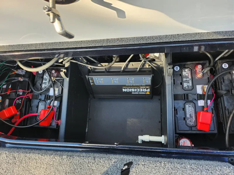Slide: The Image of 2023 Vexus VX20 boat battery compartment with wiring and charger. - 25