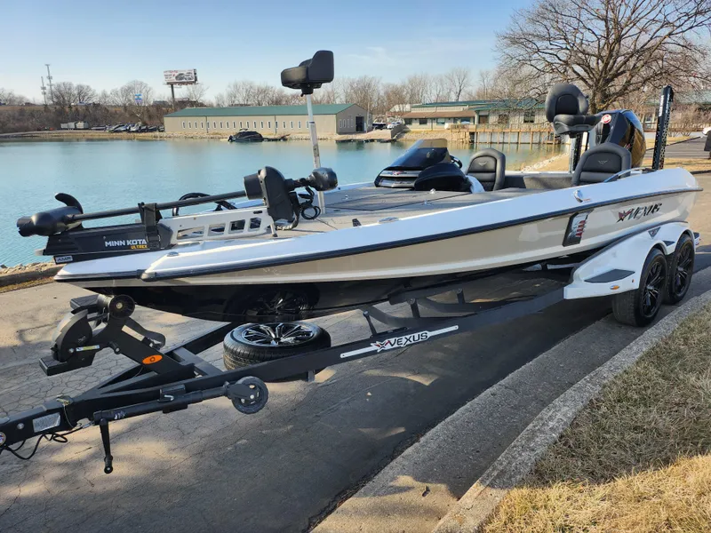 Slide: The Image of 2023 Vexus VX20 boat on trailer by a lake, ready for fishing adventures. - 8