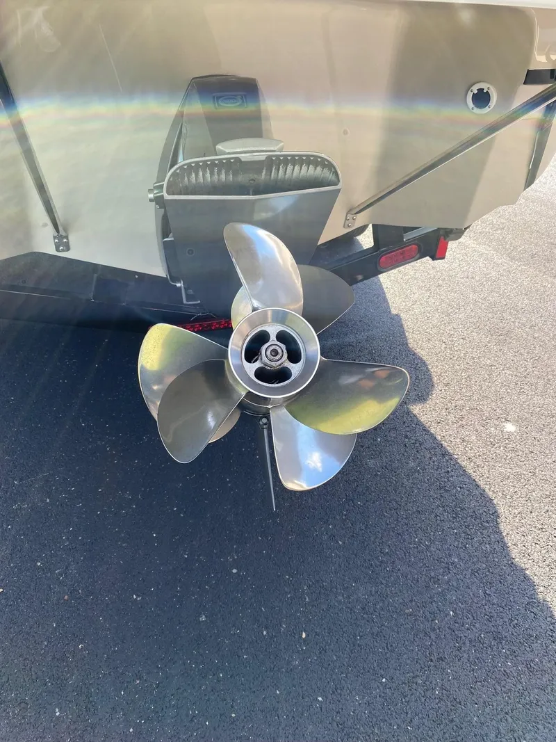 Slide: The Image of 2009 Regal 2400 Bowrider boat propeller on asphalt surface. - 5