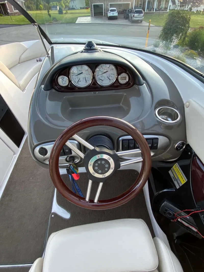Slide: The Image of 2009 Regal 2400 Bowrider dashboard with wood steering wheel and instrument panel. - 8