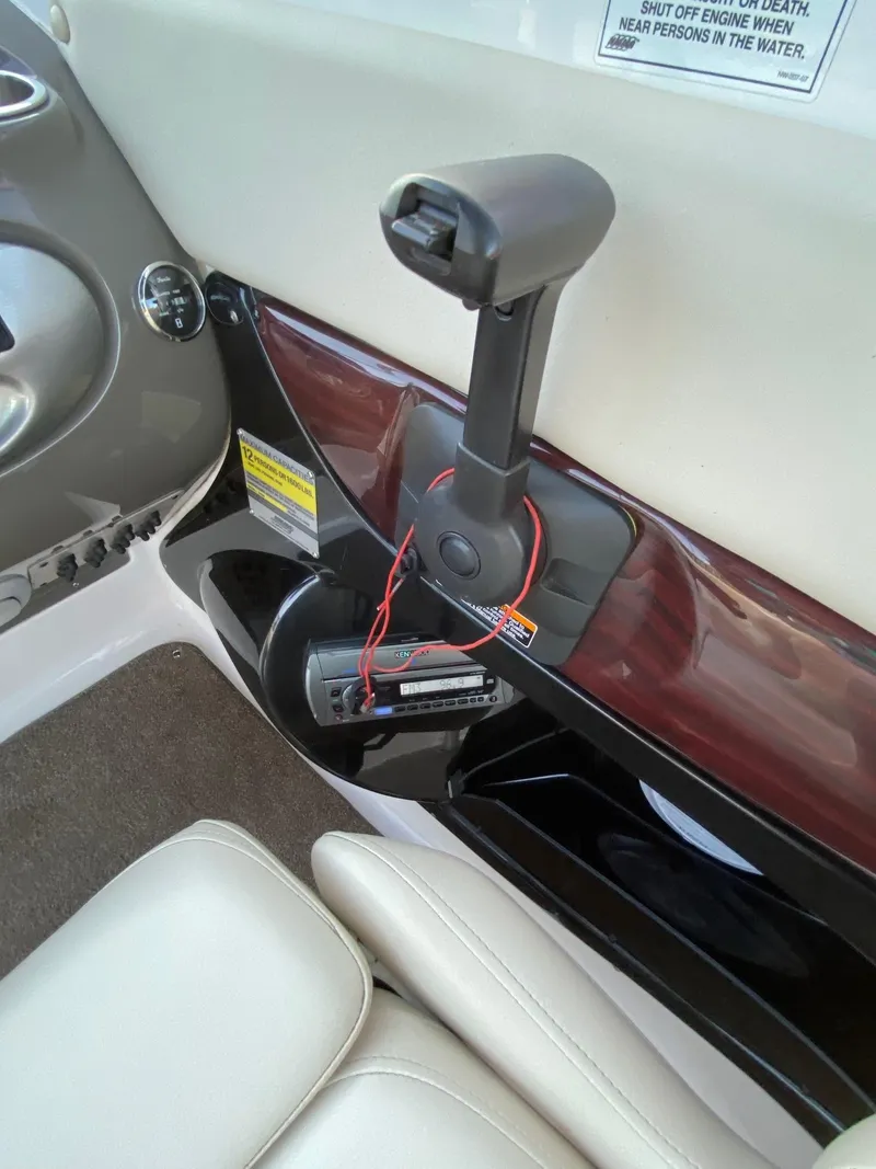 Slide: The Image of 2009 Regal 2400 Bowrider interior, featuring throttle control and dashboard details. - 9