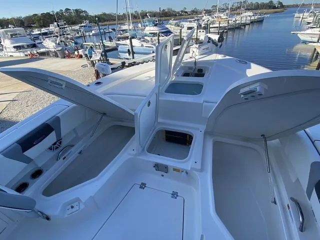 Slide: The Image of 2023 Robalo 266 Cayman boat docked at marina, showcasing sleek design and modern features. - 16