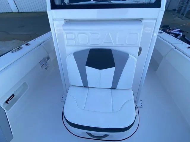 Slide: The Image of 2023 Robalo 266 Cayman boat top view against clear blue sky. - 18