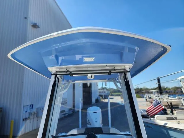 Slide: The Image of 2023 Robalo 266 Cayman boat dashboard with steering wheel and controls. - 21