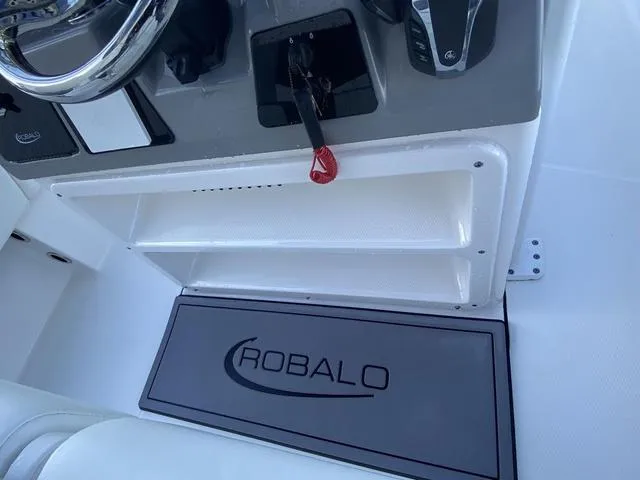 Slide: The Image of 2023 Robalo 266 Cayman boat engine detail with hydraulic components and wiring. - 29