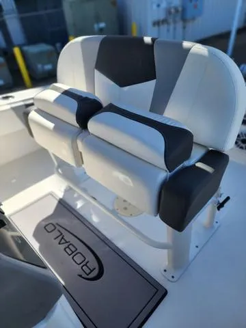 Slide: The Image of 2023 Robalo 266 Cayman boat docked at a marina with clear blue skies. - 32