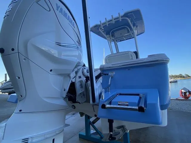 Slide: The Image of 2023 Robalo 266 Cayman boat on blue stands, showing hull details. - 35