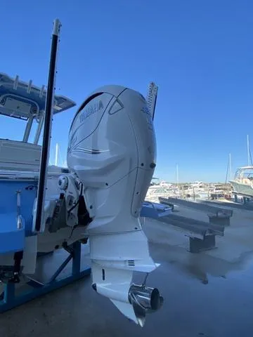 Slide: The Image of 2023 Robalo 266 Cayman boat hull on trailer, showcasing sleek design and craftsmanship. - 36