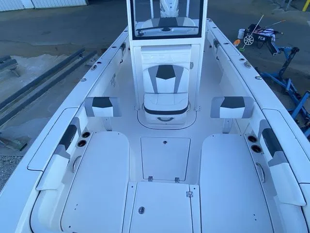 Slide: The Image of 2023 Robalo 266 Cayman boat on stand, showcasing rear view and outboard motor. - 37