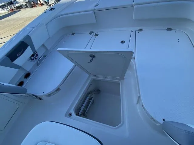 Slide: The Image of 2023 Robalo 266 Cayman boat with Yamaha engine, docked by the water. - 38