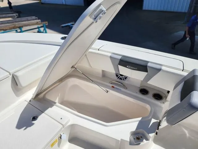 Slide: The Image of 2023 Robalo 266 Cayman boat storage compartment open, showcasing interior features. - 40