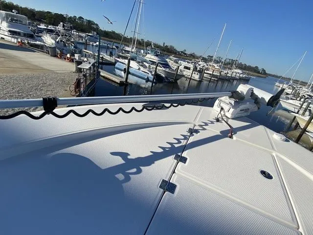 Slide: The Image of 2023 Robalo 266 Cayman boat docked at a marina under clear blue skies. - 42