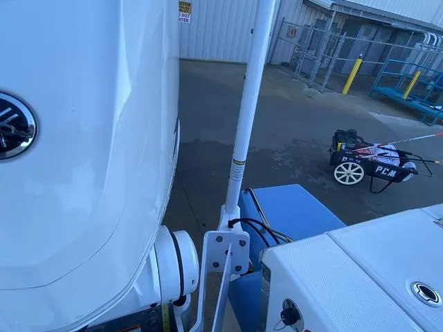 Slide: The Image of 2023 Robalo 266 Cayman boat detail with equipment in a marina setting. - 47