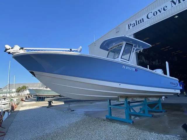 Slide: The Image of 2023 Robalo 266 Cayman boat interior with spacious seating and modern design. - 6