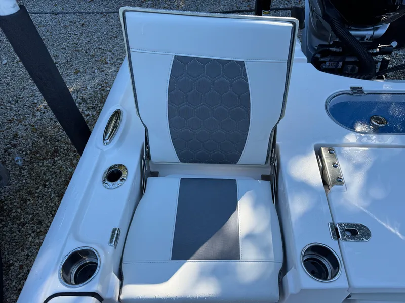 Slide: The Image of Tidewater 2500 Carolina Bay 2020 boat seat with cup holders and storage compartments. - 11