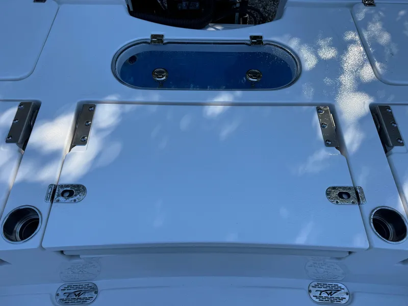 Slide: The Image of 2020 Tidewater 2500 Carolina Bay boat deck with storage compartments and cup holders. - 14