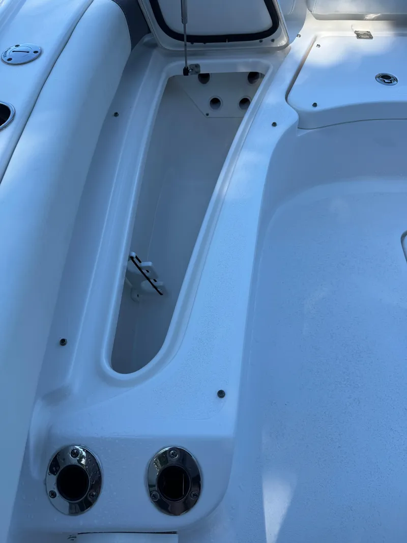 Slide: The Image of 2020 Tidewater 2500 Carolina Bay boat interior, featuring storage compartments and seating area. - 28