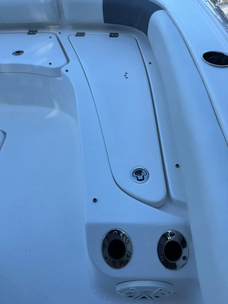 Slide: The Image of 2020 Tidewater 2500 Carolina Bay boat deck with storage compartments and cup holders. - 29