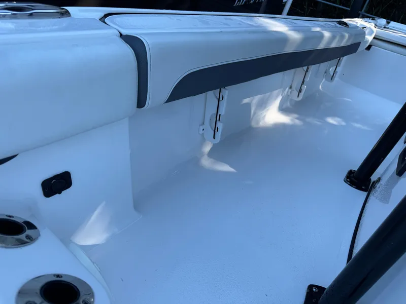 Slide: The Image of 2020 Tidewater 2500 Carolina Bay boat interior with white seating and rod holders. - 34