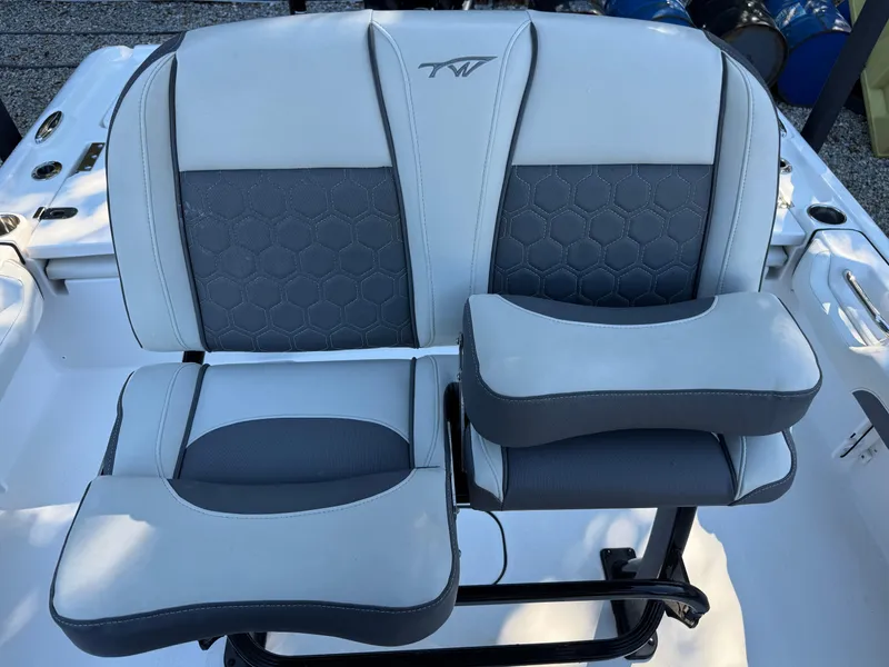 Slide: The Image of 2020 Tidewater 2500 Carolina Bay boat seating with gray upholstery and armrests. - 36
