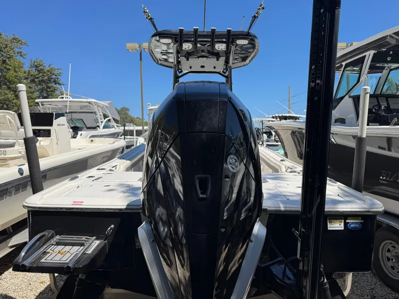 Slide: The Image of 2020 Tidewater 2500 Carolina Bay boat, rear view, in a marina with other boats. - 4