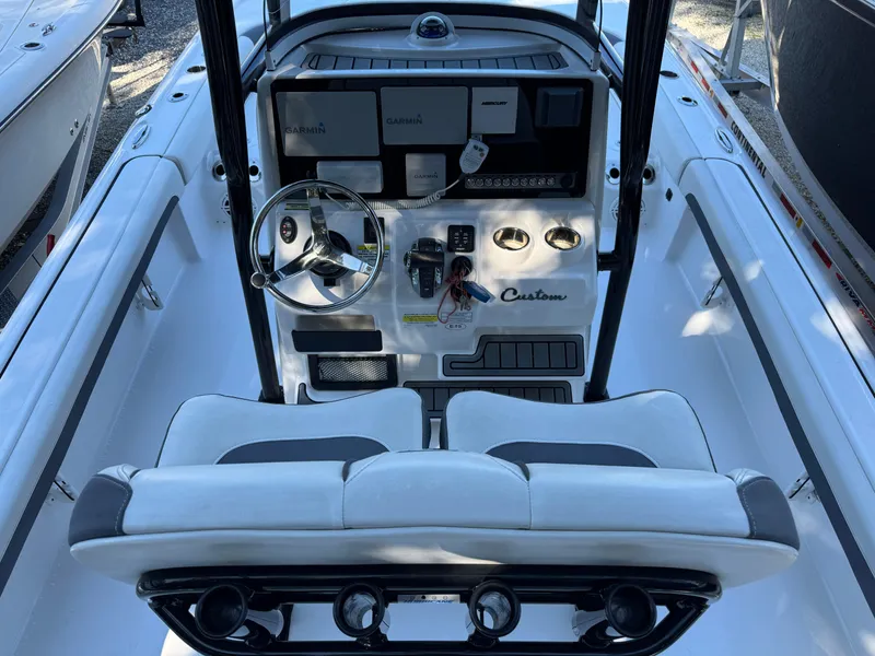 Slide: The Image of 2020 Tidewater 2500 Carolina Bay boat cockpit with steering wheel and control panel. - 7