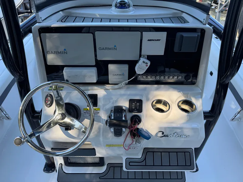 Slide: The Image of 2020 Tidewater 2500 Carolina Bay boat dashboard with Garmin electronics and steering wheel. - 8