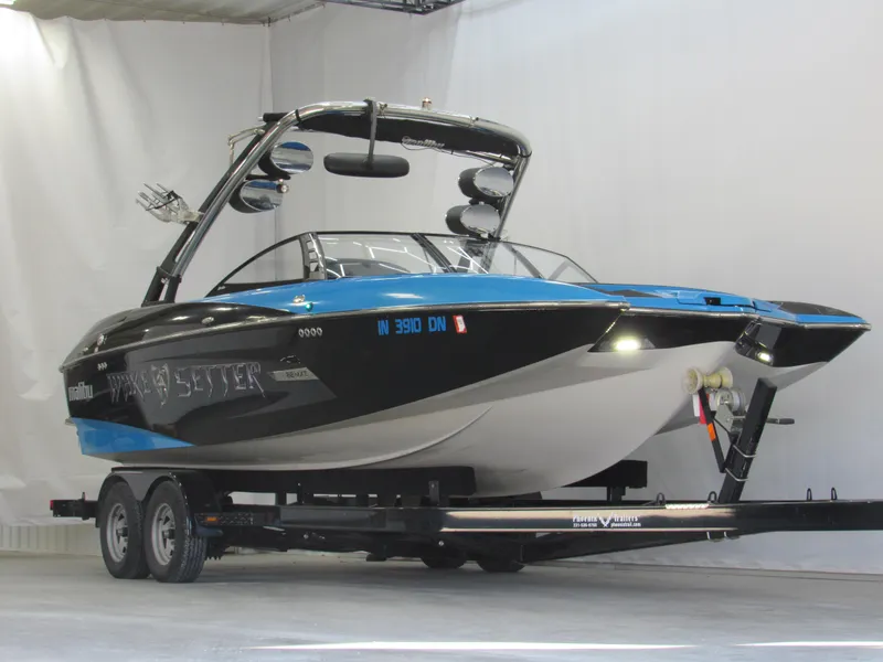 Slide: The Image of 2012 Malibu Wakesetter 22 MXZ boat on trailer in indoor setting. - 1