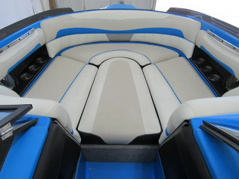 Slide: The Image of 2012 Malibu Wakesetter 22 MXZ interior with blue and white seating. - 11
