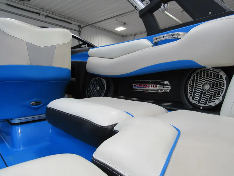 Slide: The Image of Interior of 2012 Malibu Wakesetter 22 MXZ with blue and white seating and speakers. - 4