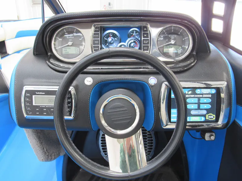 Slide: The Image of Dashboard of 2012 Malibu Wakesetter 22 MXZ with steering wheel and control panels. - 9