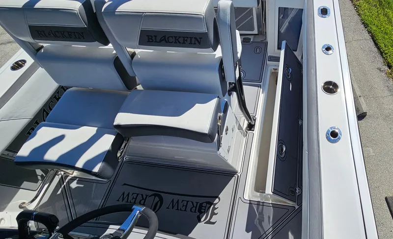 Slide: The Image of 2020 Blackfin 272 CC boat interior with seating and steering wheel. - 11