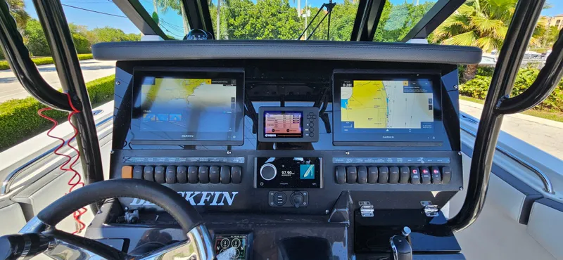 Slide: The Image of 2020 Blackfin 272 CC boat dashboard with dual navigation screens and controls. - 12