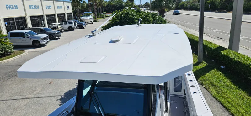 Slide: The Image of 2020 Blackfin 272 CC boat parked near a dealership, viewed from above. - 19