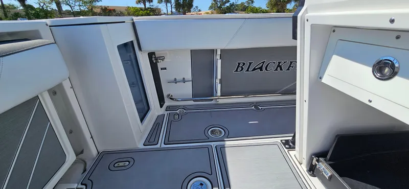 Slide: The Image of 2020 Blackfin 272 CC boat interior with sleek design and storage compartments. - 20