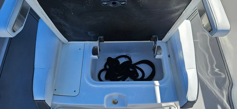 Slide: The Image of Open storage compartment on 2020 Blackfin 272 CC boat with coiled rope inside. - 23