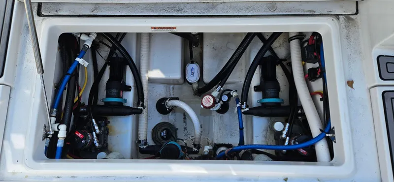 Slide: The Image of 2020 Blackfin 272 CC boat engine compartment with various hoses and components. - 26