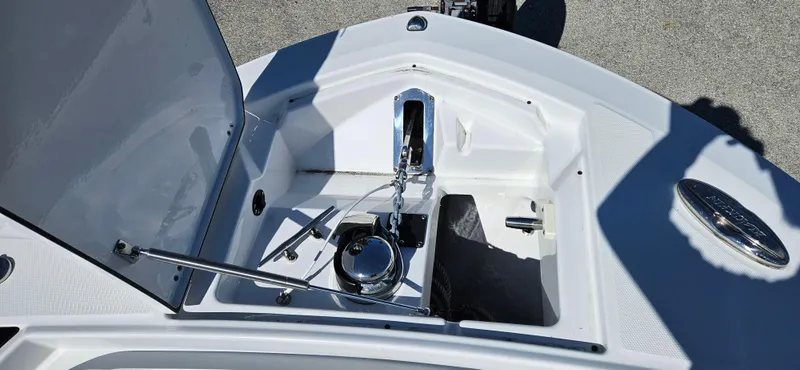 Slide: The Image of 2020 Blackfin 272 CC boat anchor compartment with open hatch and chain. - 29