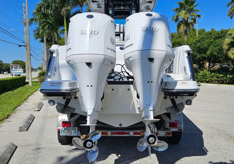Slide: The Image of 2020 Blackfin 272 CC boat with twin outboard engines on a sunny street. - 3