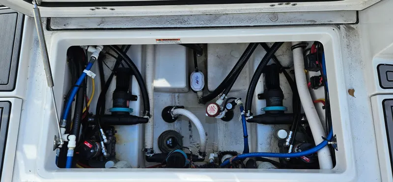 Slide: The Image of 2020 Blackfin 272 CC boat plumbing system with hoses and valves. - 31