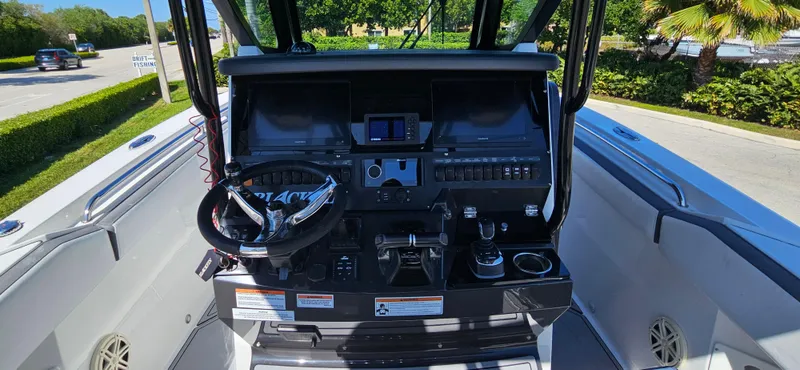Slide: The Image of 2020 Blackfin 272 CC boat cockpit with steering wheel and control panel. - 32
