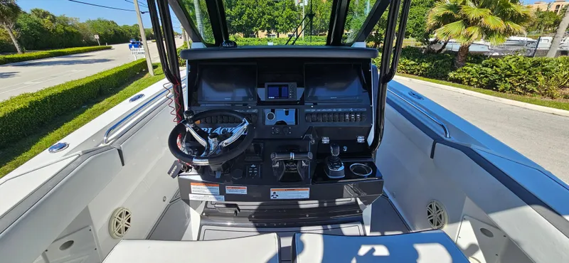 Slide: The Image of 2020 Blackfin 272 CC boat cockpit with steering wheel and control panel. - 33