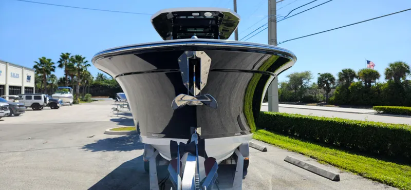 Slide: The Image of 2020 Blackfin 272 CC boat, front view, parked outdoors on a sunny day. - 4